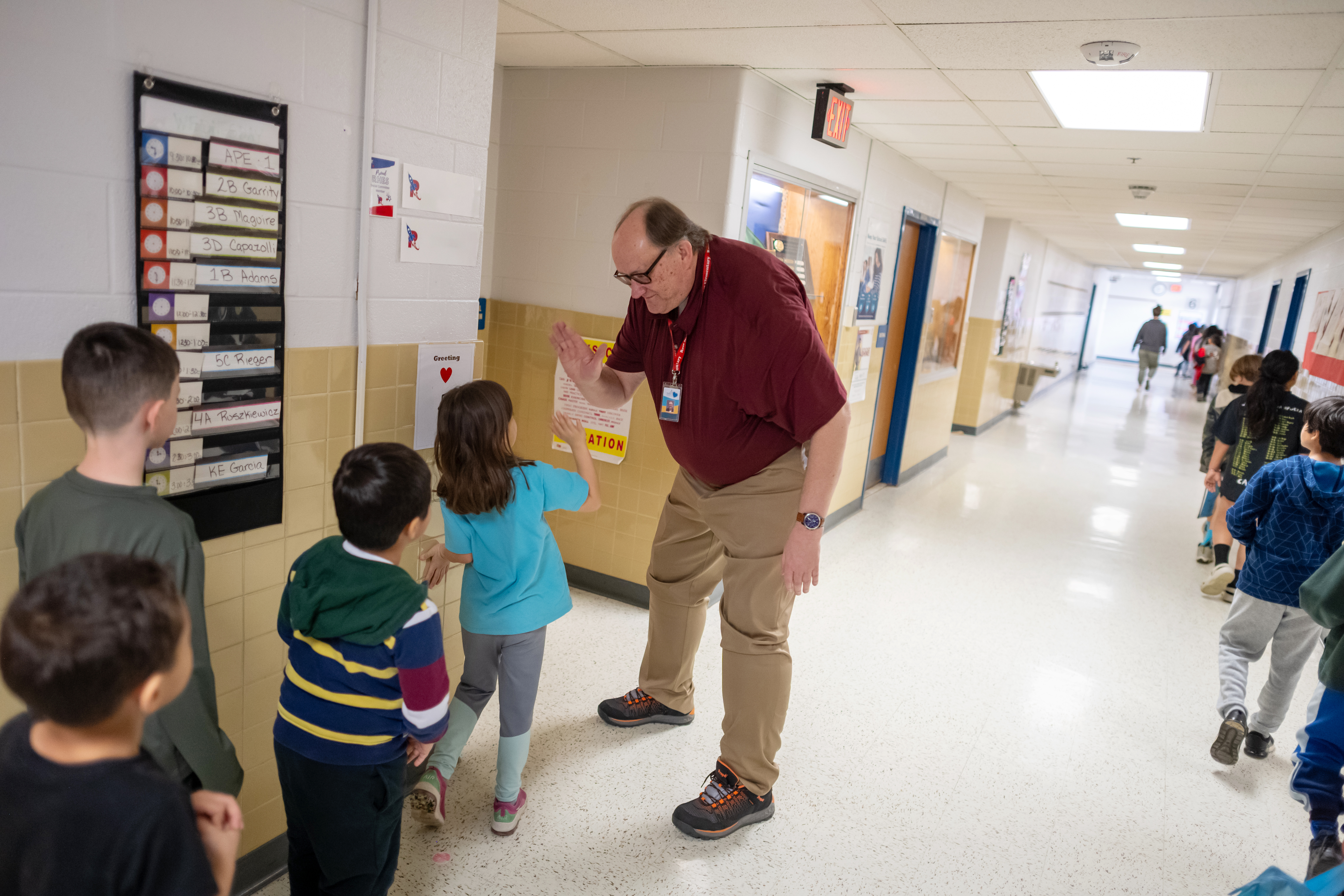 A teacher high fives his students