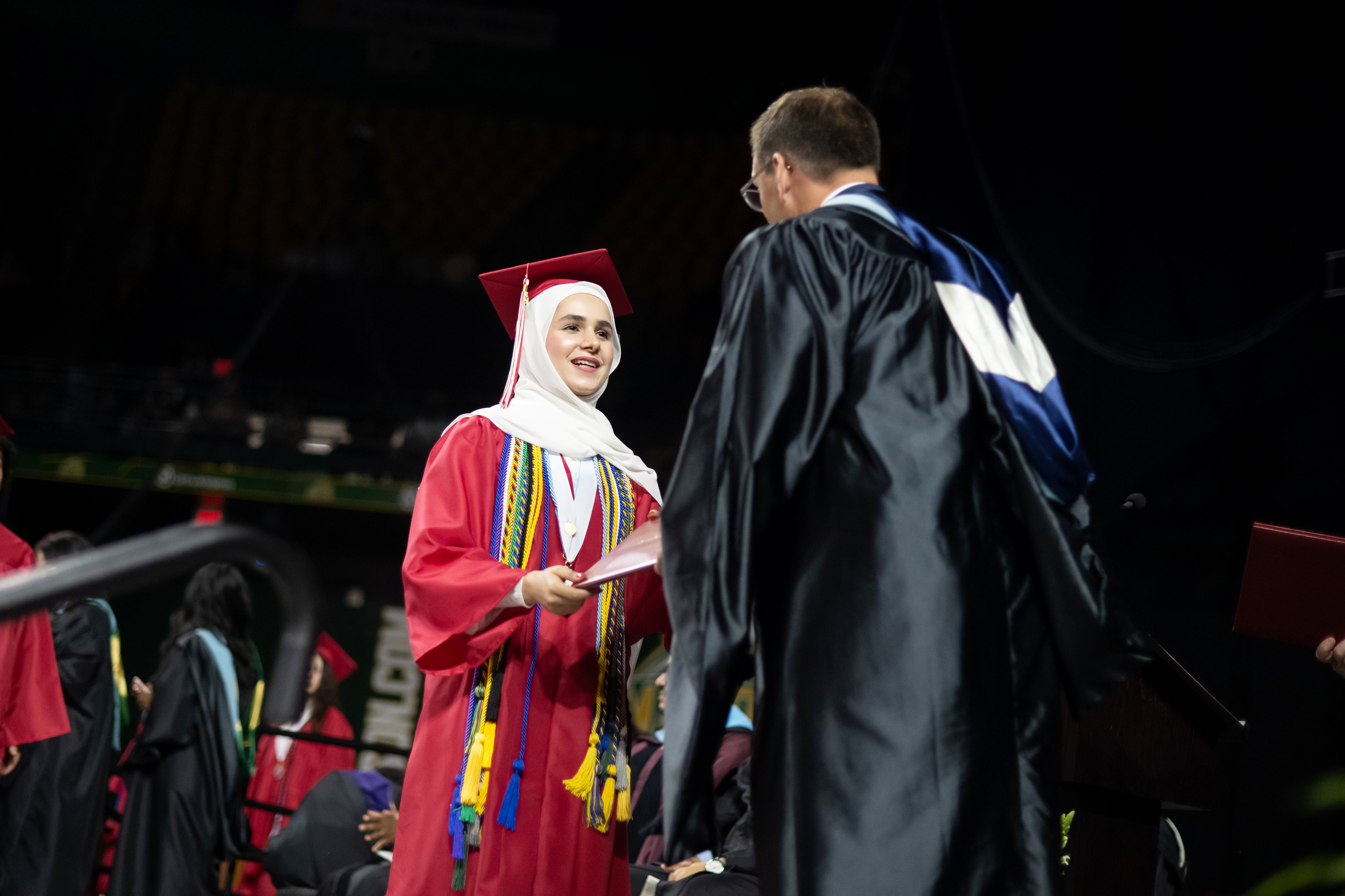 Annandale High School grad Husna Basiri gets her diploma from Principal Shawn DeRose.