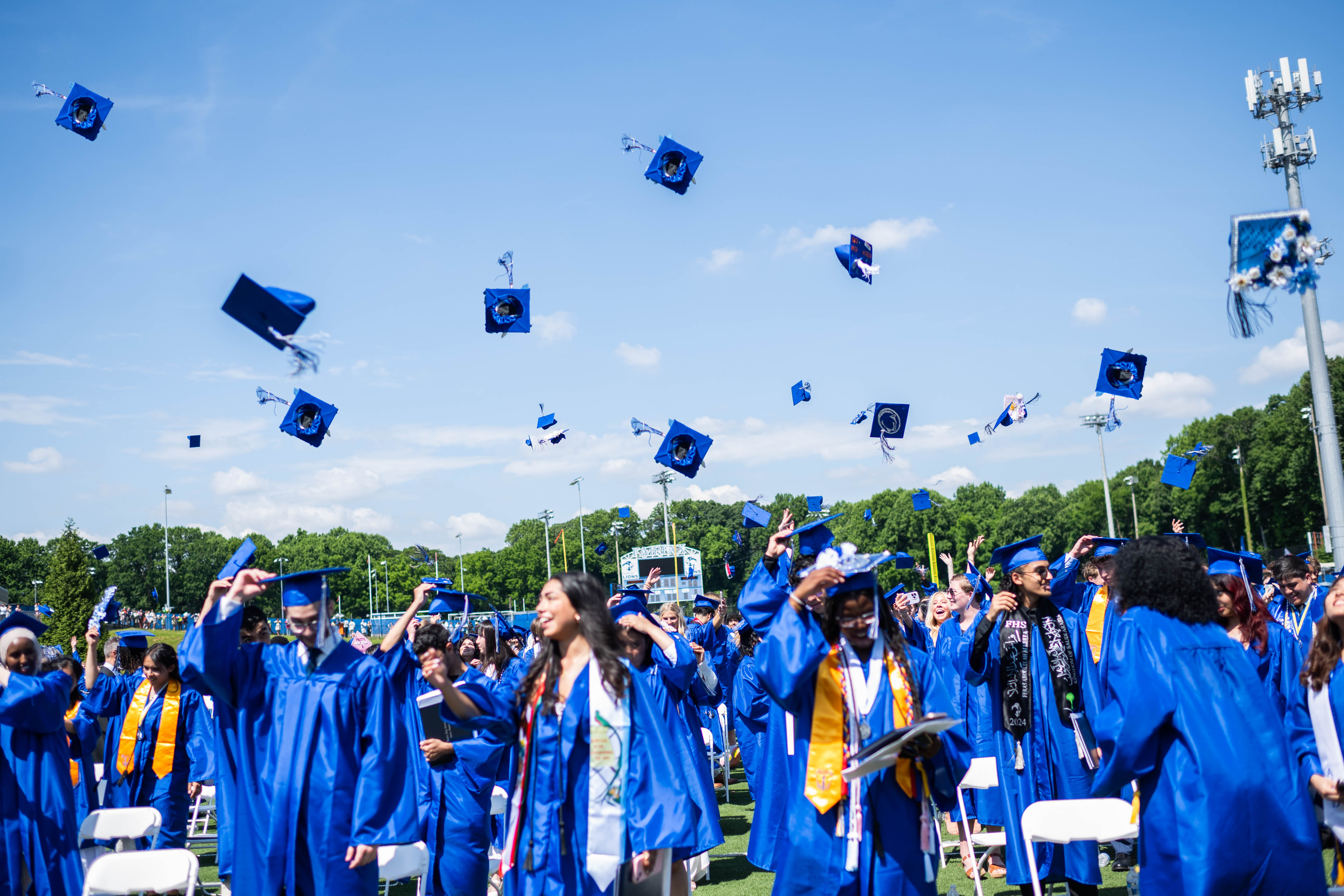 Fairfax HS Class of 2024 throws their caps during graduation