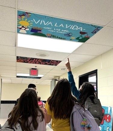 Students pointing at artwork on the ceiling of Hunt Valley ES