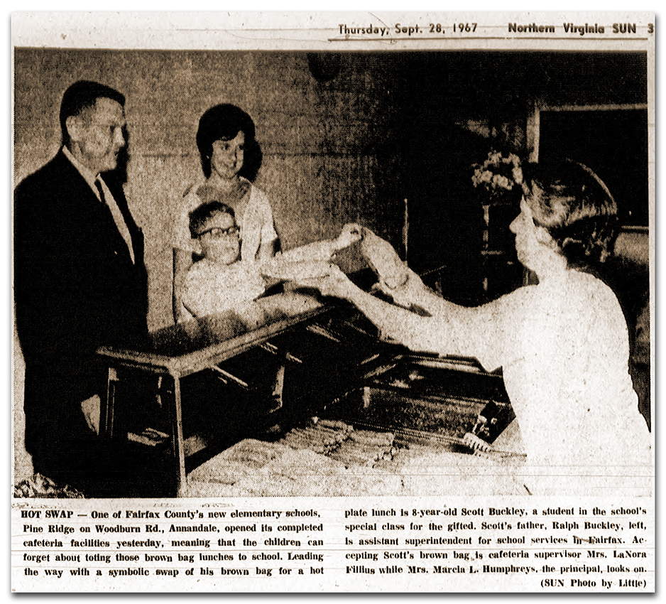 Newspaper clipping showing a photograph of a student interacting with a cafeteria worker. The caption reads: Hot Swap – one of Fairfax County’s new elementary schools, Pine Ridge on Woodburn Road, Annandale, opened its completed cafeteria facilities yesterday, meaning that the children can forget about toting those brown bag lunches to school. Leading the way with a symbolic swap of his brown bag for a hot plate lunch is 8-year-old Scott Buckley, a student in the school’s special class for the gifted. Scott’s father, Ralph Buckley, left, is assistant superintendent for school services in Fairfax. Accepting Scott’s brown bag is cafeteria supervisor Mrs. LaNora Fillius while Mrs. Marcia L. Humphreys, the principal, looks on.