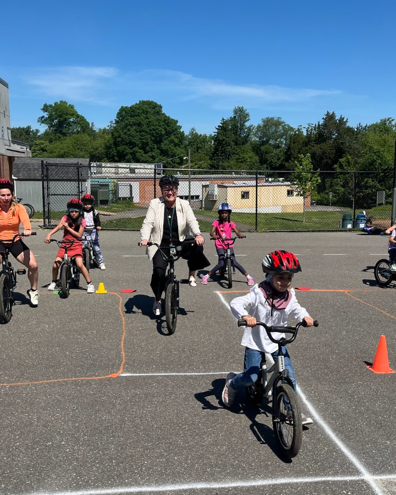 Dr. Reid bikes with Woodburn ES students and staff