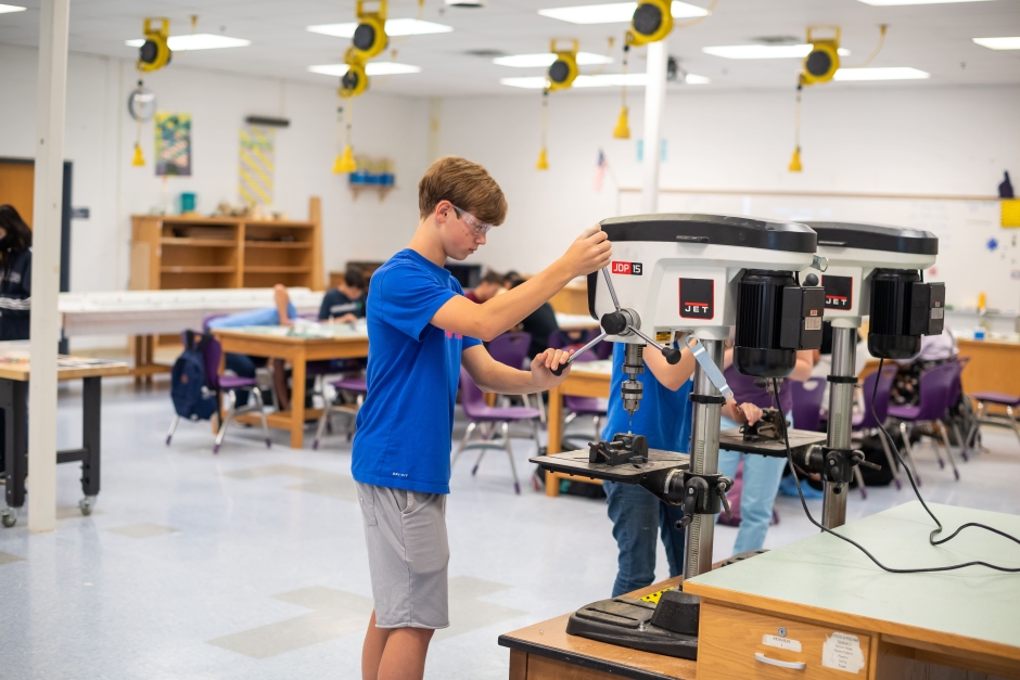 student using a drill press during the CTE Summer Academy