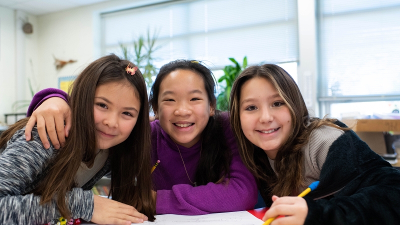 Three students smiling.