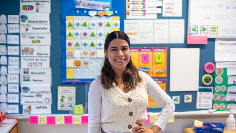 A teacher posing for a picture in her classroom.