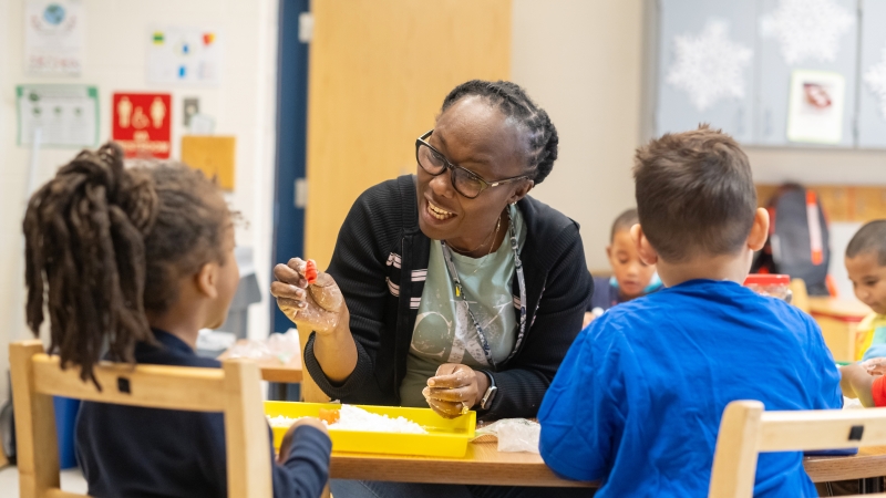 A teacher in training works with students