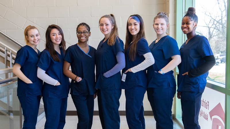 seven female medical students standing in a line