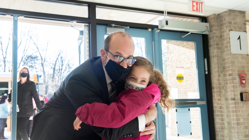 A father hugging his daughter.