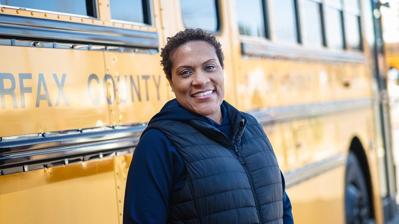 Synnethia poses outside of her bus