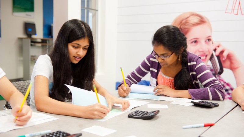 two female students working at a table