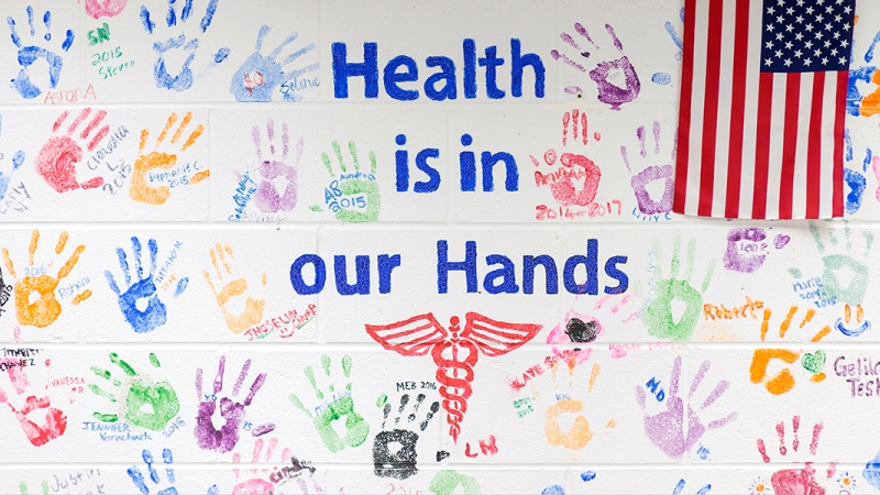 Health is in our hands painted on wall. 