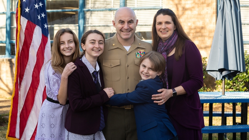 A military family posing for a picture.