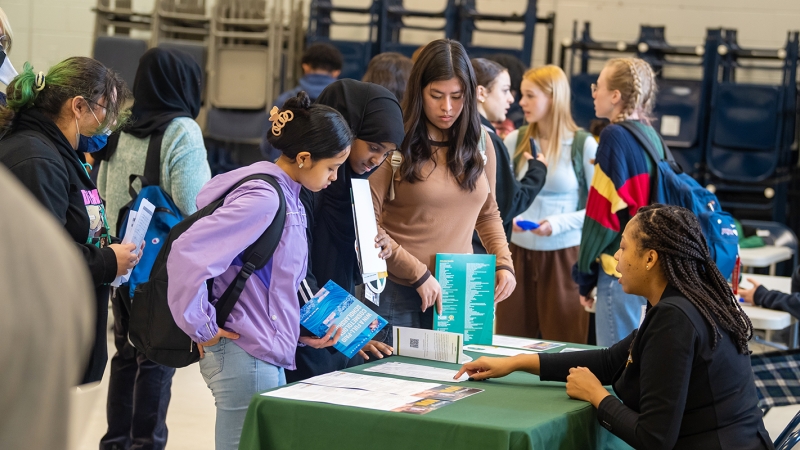 a group of students looking at information on a table