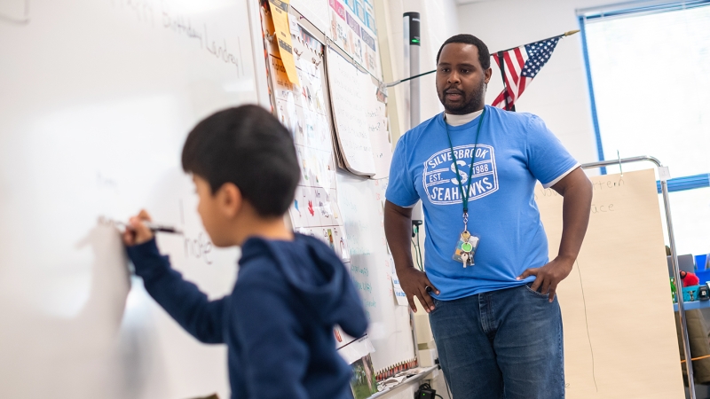 Saed Mohamed teaches at a white board