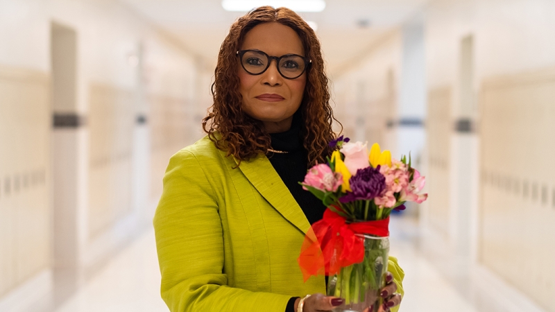 Social worker holds flowers