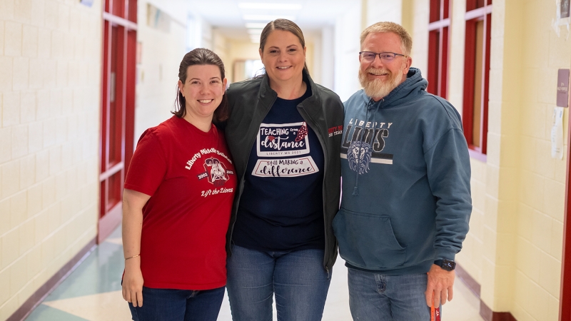 Three assistant principals in a hallway