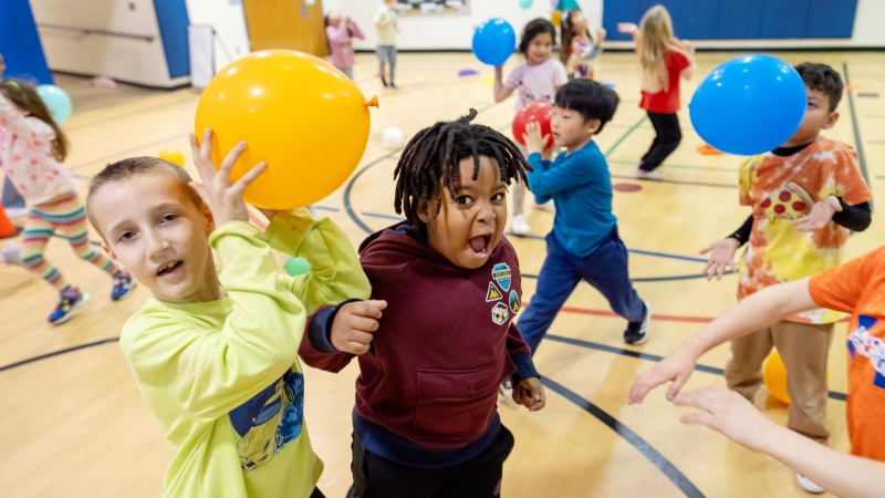 Kids play with balloons. 