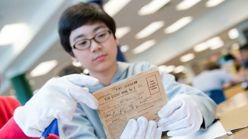 Young boy examining an historical document.