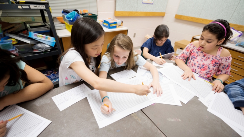 four students analyzing data