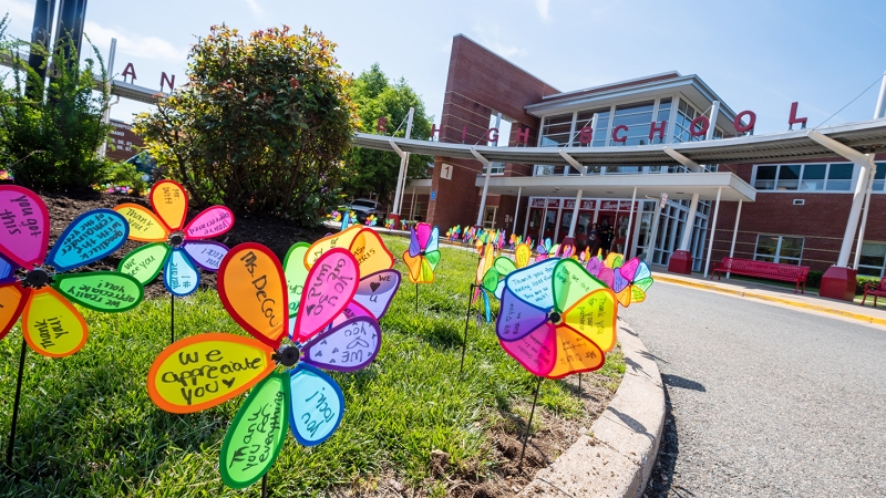 Teacher appreciation notes written on colorful plastic flowers. 