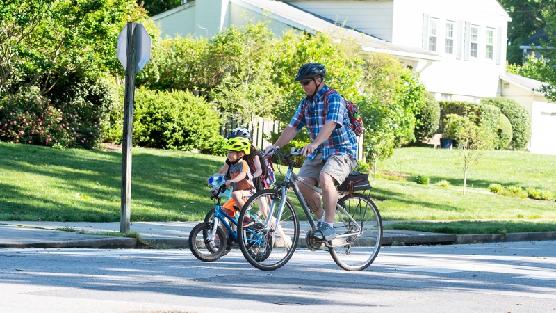 A family bikes to school. 