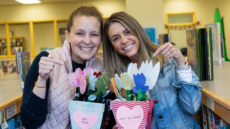 Teachers hold flowers