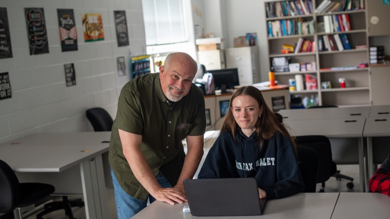 teacher and student together at a table