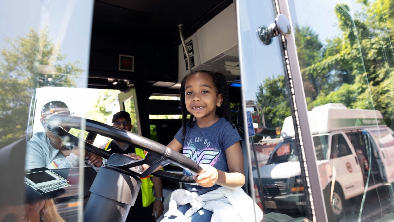 A student sits at the wheel of a parked truck