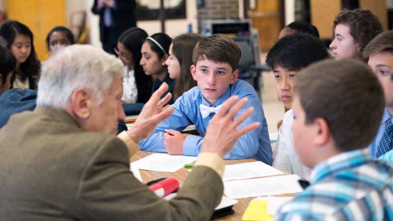 man talking to students