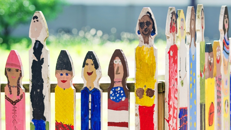 fence posts with paintings of childrens faces