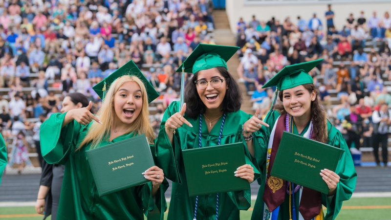 Students in green graduation robes. 