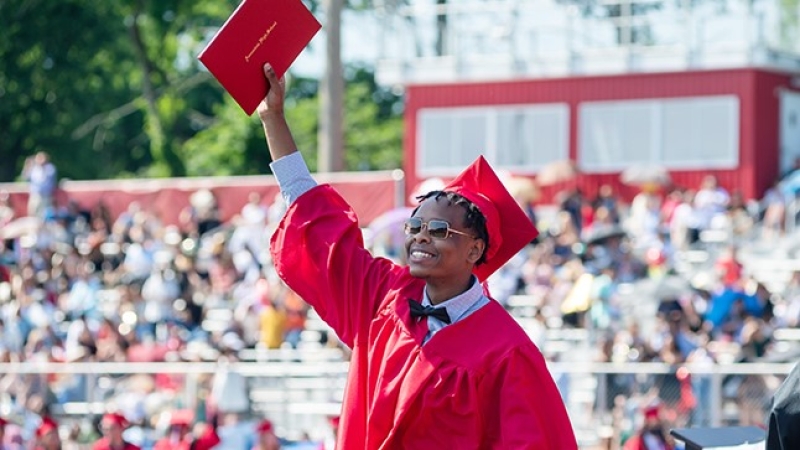 recent graduate holding a diploma