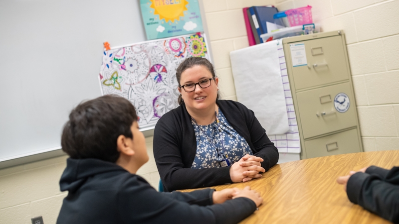 A social worker talks to a student. 