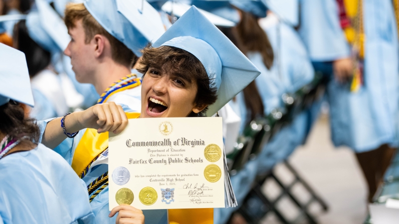 A grad displays his diploma