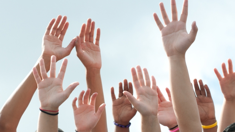 Picture of raised hands, representing opting into external research study.