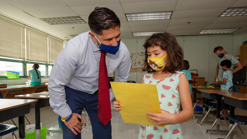 Michael Astudillo checks out a student's work.