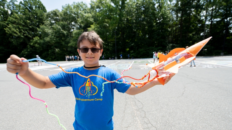 A student shows off a model rocket