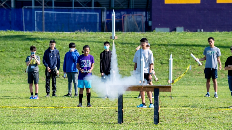 A group of students watching rockets take off