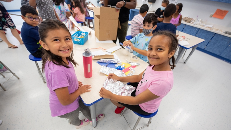 two students working together at a table