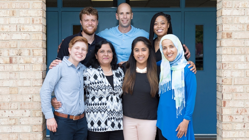 Members of the community standing outside of building