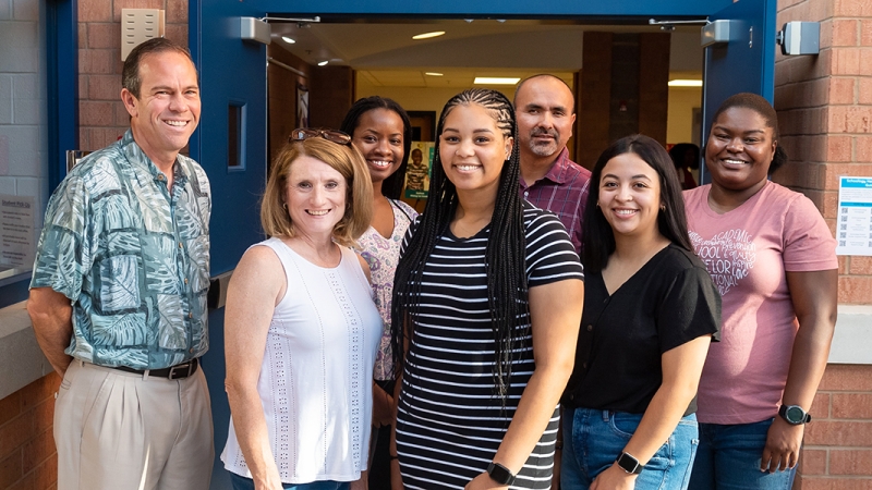 Seven new teachers smile for a photo