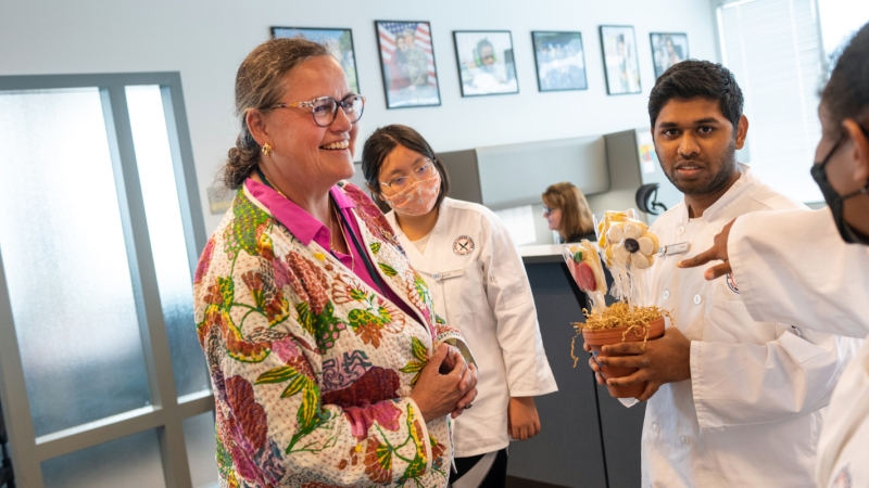 Dr. Reid is presented with a cookie bouquet made by students