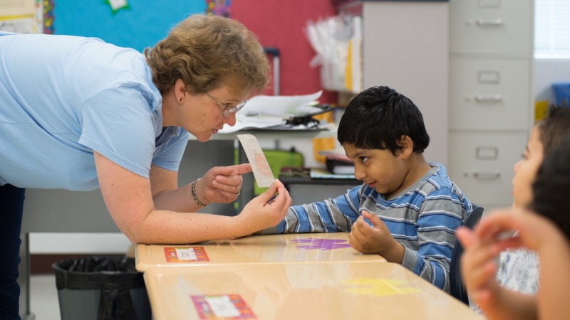 Photo of a speech pathologist working with a student.