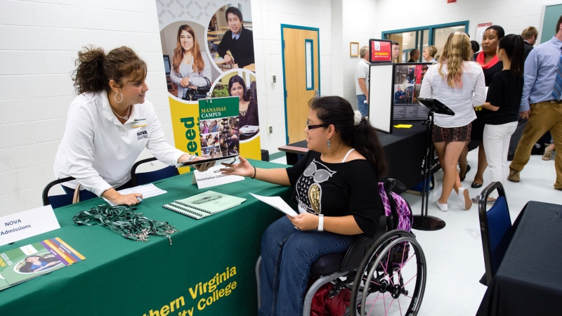 Student in wheelchair receiving information.