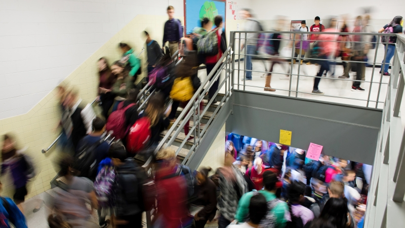 many students in the stairwell and hallway of a school