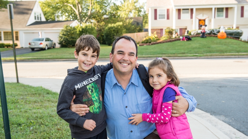 Students standing with their father.