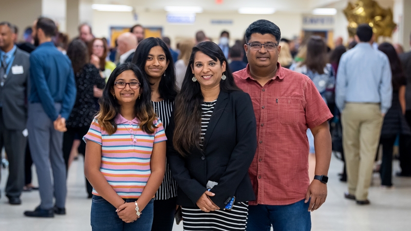 four family members standing in a school hallway