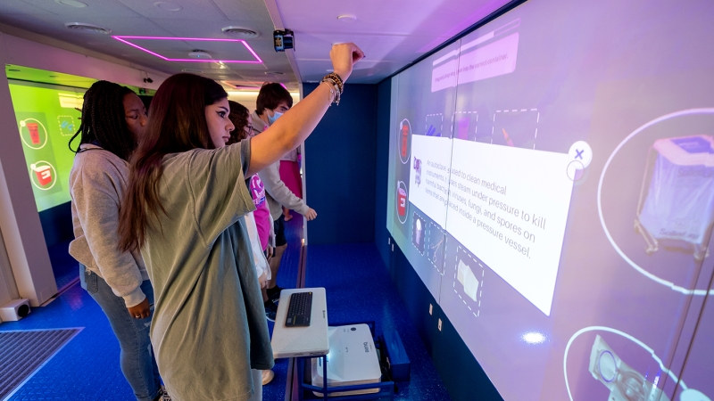 Students use virtual reality aboard the Immersive Learning Center. 