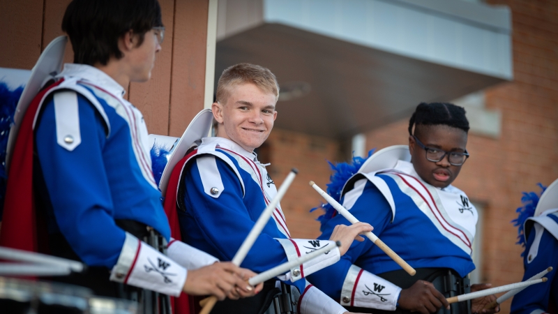 Michael Gouin prepares to perform at a football game. 