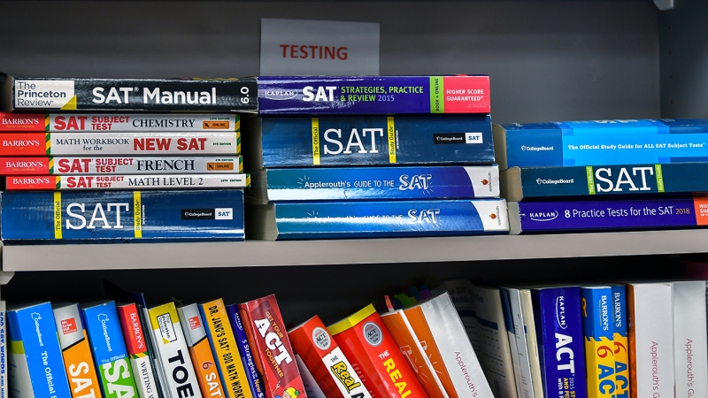 college admissions test preparation books on a bookshelf